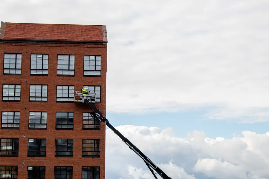 Technician carrying out leak detection on a commercial building